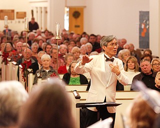 Dr. Hae-Jong Lee directs the Stambaugh Chorus in performing Wishes and Candles as part of the Concerts Under the Dome at First Presbyterian Church in Columbiana on Sunday night. EMILY MATTHEWS | THE VINDICATOR