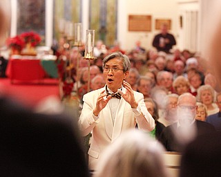 Dr. Hae-Jong Lee directs the Stambaugh Chorus in performing Wishes and Candles as part of the Concerts Under the Dome at First Presbyterian Church in Columbiana on Sunday night. EMILY MATTHEWS | THE VINDICATOR