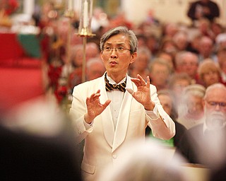 Dr. Hae-Jong Lee directs the Stambaugh Chorus in performing Wishes and Candles as part of the Concerts Under the Dome at First Presbyterian Church in Columbiana on Sunday night. EMILY MATTHEWS | THE VINDICATOR