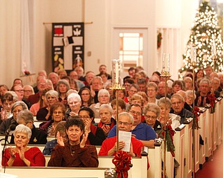 The audience claps after the Stambaugh Chorus performs Wishes and Candles as part of the Concerts Under the Dome at First Presbyterian Church in Columbiana on Sunday night. EMILY MATTHEWS | THE VINDICATOR