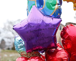 A balloon with a message written on it is one of the many balloons and teddy bears placed outside 434 Parkcliffe Avenue in Youngstown in memory of the five children who died from a house fire early this morning. EMILY MATTHEWS | THE VINDICATOR