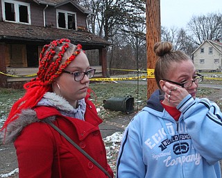 William D. Lewis The Vindicator Melissa Thomas, right, wipes away a tear  as her daughter Elissa Simione looks on at the scene of a fire in Youngstown where 5 people died early this morning. They left stuffed animals at a make shift memorial at the scene.