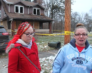 William D. Lewis The Vindicator Melissa Thomas, right, wipes away a tear  as her daughter Elissa Simione looks on at the scene of a fire in Youngstown where 5 people died early this morning. They left stuffed animals at a make shift memorial at the scene.