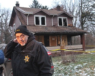 William D. Lewis The Vindicator Bob Sharp with the Ohio State Fire Marshall's office on the scene of a house fire in Youngstown where 5 people died.