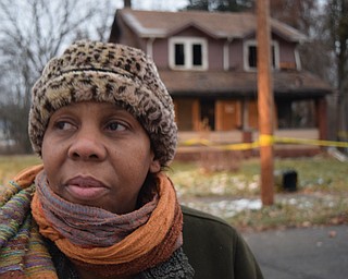 William D. Lewis The Vindicator Sandra Murphy, owner of Flambeau's Resurant in Youngstown looks on at the scene of a fire in Youngstown where 5 people died early this morning. She said when things like this happen we have to help.