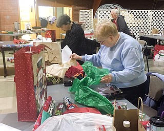 Community volunteers wrap gifts for more than 89 Blott Guy Elementary students. The Blott Holiday Project provides gifts and clothing for needy children in the Liberty community. 