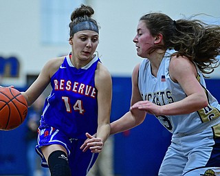 LOWELLVILLE, OHIO - DECEMBER 10, 2018: Western Reserve's Kennedy Miller drives on Lowellville's Maddie Kelly during the first half of their game, Monday night at Lowellville High School. DAVID DERMER | THE VINDICATOR