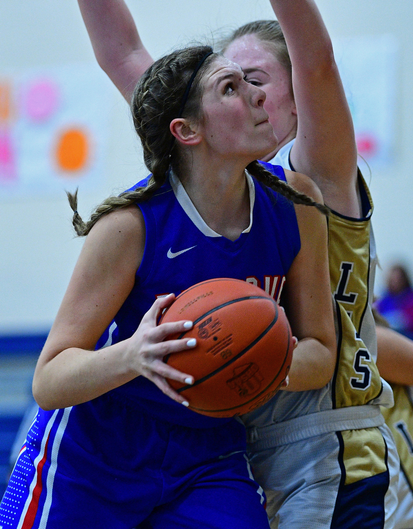 LOWELLVILLE, OHIO - DECEMBER 10, 2018: Western Reserve's Dani Vuletich goes to the basket against Lowellville's Marah Bellis during the first half of their game, Monday night at Lowellville High School. DAVID DERMER | THE VINDICATOR