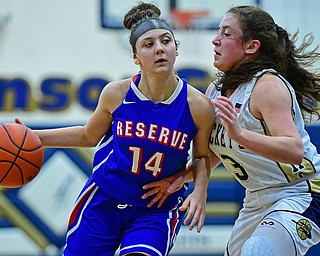 LOWELLVILLE, OHIO - DECEMBER 10, 2018: Western Reserve's Kennedy Miller drives on Lowellville's Maddie Kelly during the first half of their game, Monday night at Lowellville High School. DAVID DERMER | THE VINDICATOR