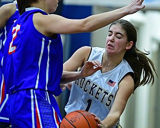 LOWELLVILLE, OHIO - DECEMBER 10, 2018: Lowellville's Sammie Kelly bounces the ball off the leg of Western Reserve's Brooke Morris after being trapped in the corner during the second half of their game, Monday night at Lowellville High School. DAVID DERMER | THE VINDICATOR