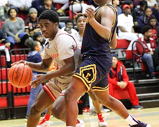 Chaney's Jamison Tubbs dribbles the ball while East's Mar'Quel Anderson tries to block him during their game at Chaney High School on Tuesday night. EMILY MATTHEWS | THE VINDICATOR