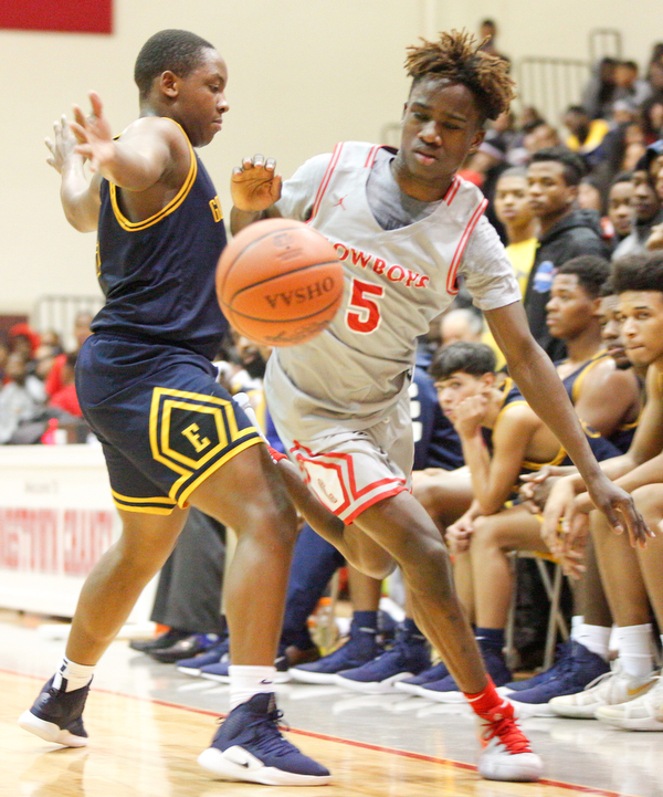 Chaney's Cameron Lawrence dribbles the ball while East's Carl Sadler blocks him during their game at Chaney High School on Tuesday night. EMILY MATTHEWS | THE VINDICATOR