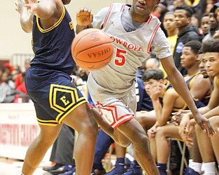 Chaney's Cameron Lawrence dribbles the ball while East's Carl Sadler blocks him during their game at Chaney High School on Tuesday night. EMILY MATTHEWS | THE VINDICATOR