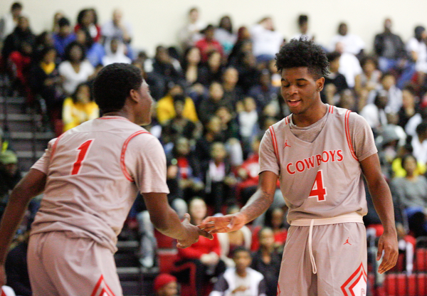 Chaney's Jamison Tubbs, left, and Ryan Clark high-five during their game against East at Chaney High School on Tuesday night. EMILY MATTHEWS | THE VINDICATOR