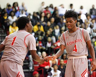 Chaney's Jamison Tubbs, left, and Ryan Clark high-five during their game against East at Chaney High School on Tuesday night. EMILY MATTHEWS | THE VINDICATOR