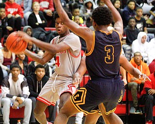 Chaney's Ryan Clark looks to pass the ball while East's Deland Richardson tries to block him during their game at Chaney High School on Tuesday night. EMILY MATTHEWS | THE VINDICATOR