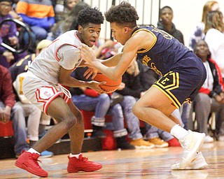 Chaney's Ryan Clark looks to pass the ball while East's Dasan Dupree tries to block him during their game at Chaney High School on Tuesday night. EMILY MATTHEWS | THE VINDICATOR