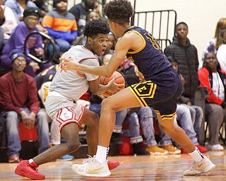 Chaney's Ryan Clark looks to pass the ball while East's Dasan Dupree tries to block him during their game at Chaney High School on Tuesday night. EMILY MATTHEWS | THE VINDICATOR