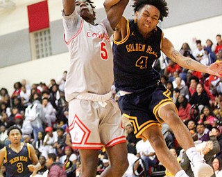 East's Damico Jackson III hits the ball away from Chaney's Cameron Lawrence during their game at Chaney High School on Tuesday night. EMILY MATTHEWS | THE VINDICATOR