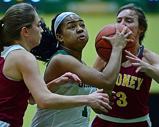 YOUNGSTOWN, OHIO - DECEMBER 12, 2018: Ursuline's Dayshanette Harris drives on Mooney's Cameryn Olesh, right, and Camden Hergenrother during the first half of their game, Wednesday night at Ursuline High School. DAVID DERMER | THE VINDICATOR