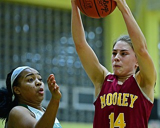 YOUNGSTOWN, OHIO - DECEMBER 12, 2018: Mooney's Camden Hergenrother grabs a rebound away from Ursuline's Dayshanette Harris during the first half of their game, Wednesday night at Ursuline High School. DAVID DERMER | THE VINDICATOR