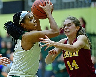YOUNGSTOWN, OHIO - DECEMBER 12, 2018: Ursuline's Dayshanette Harris goes to the basket against Mooney's Camden Hergenrother during the second half of their game, Wednesday night at Ursuline High School. DAVID DERMER | THE VINDICATOR
