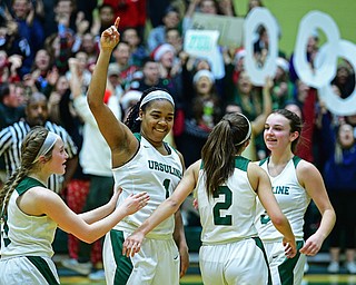 YOUNGSTOWN, OHIO - DECEMBER 12, 2018: Ursuline's Dayshanette Harris, venter, is congratulated by her teammates including Rachel Fabry, Cara McNally and Jamie Nelson after scoring her 2000th career point on a free throw during the second half of their game, Wednesday night at Ursuline High School. DAVID DERMER | THE VINDICATOR