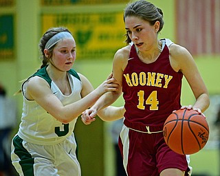 YOUNGSTOWN, OHIO - DECEMBER 12, 2018: Mooney's Camden Hergenrother is grabbed by Ursuline's Jamie Nelson during the second half of their game, Wednesday night at Ursuline High School. DAVID DERMER | THE VINDICATOR
