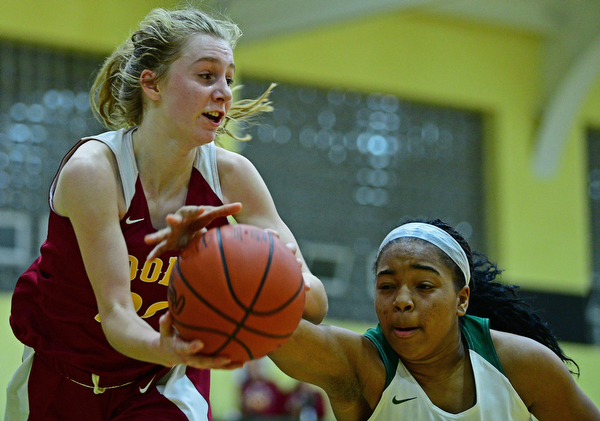 YOUNGSTOWN, OHIO - DECEMBER 12, 2018: Mooney's Katie Hough and Ursuline's Dayshanette Harris battle for a rebound during the second half of their game, Wednesday night at Ursuline High School. DAVID DERMER | THE VINDICATOR