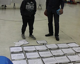 Neighbors | Abby Slanker.A Hilltop Elementary School third-grade student contemplated the Minecraft activity at a math station with the help of a volunteer during the school’s annual STEM Week on Nov. 8.