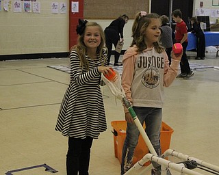 Neighbors | Abby Slanker.Hilltop Elementary School third-grade students prepared to launch blocks at a structure built by their classmates at an engineering station during the school’s annual STEM Week.