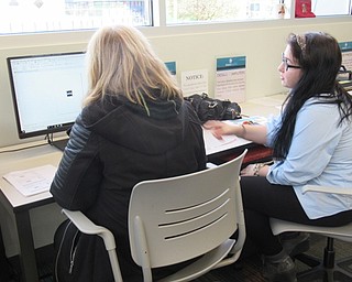 Neighbors | Jessica Harker .Librarian Hannah Matulek taught community members how to use software designed to create vinyl stickers at the Michael Kusalaba library's Maker Space.