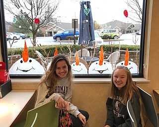 Neighbors | Submitted.Hannah Ryan and Isabelle Dwyer painted snowmen looking up with carrot noses in the air for Akron Children's Hospital on Dec. 1.