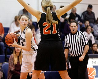 McDonald's Maddy Howard looks to pass the ball as Mineral Ridge's Noelle Bukovina tries to block her during their game at McDonald High School on Thursday night. EMILY MATTHEWS | THE VINDICATOR