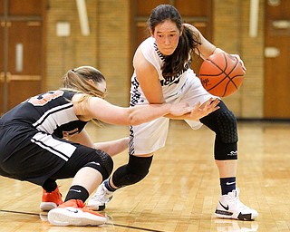 Mineral Ridge's Alexa Harkins reaches for the ball while McDonald's Sophia Costantino dribbles during their game at McDonald High School on Thursday night. EMILY MATTHEWS | THE VINDICATOR