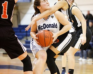 McDonald's Taylor Tuchek gets ready to shoot while Mineral Ridge's Candice Miller, right, and Lizzy Panic, left, try to block her during their game at McDonald High School on Thursday night. EMILY MATTHEWS | THE VINDICATOR