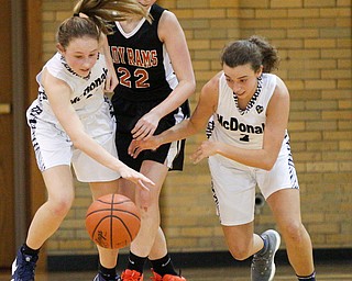 McDonald's Maddy Howard, left, and Olivia Perry, right, try to get the ball away from Mineral Ridge's Fran Kesner during their game at McDonald High School on Thursday night. EMILY MATTHEWS | THE VINDICATOR