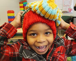 William D. Lewis The vindicator  Wilson preschooler Ke'on Spivey, 4,  checks out winter hats that were donated to the school.