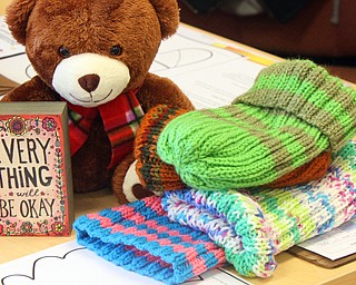 William D. Lewis The vindicator  HATS DONATED TO STUDENTS AT WILSON SCHOOL RESSST ON A TEACHERS DESK.