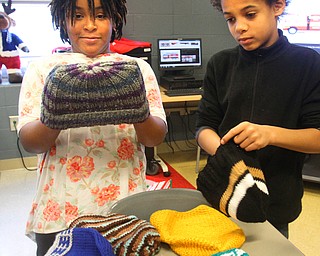 William D. Lewis The vindicator  Wilson 4th graders Nahjae Page, left, and Jonathon Hardy check out winter hats that were donated to them. They are classmates of girl who died in house fire.