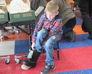 Neighbors | Jessica Harker.Zachary May was one of 28 students who received a new pair of boots through Making Kids Count at Austintown Elementary School on Dec. 3.