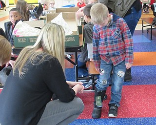 Neighbors | Jessica Harker.Zachary May, a student at Austintown Elementary School, received a new pair of boots on Dec. 3.