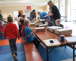 Neighbors | Jessica Harker.AES Counselors and Making Kids Count representatives handed out 28 pairs of boots to Austintown students Dec. 3.