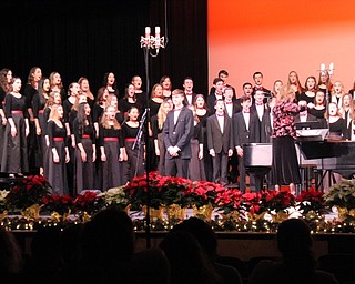 Neighbors | Abby Slanker.To close the Canfield High School choral department’s winter concert, all choirs joined together on stage to sing “God Rest You Merry Gentlemen” with a solo by Joey Bruno (front).