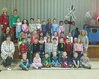 Neighbors | Submitted.Poland preschool teachers and students pose in front of the train tent during their Polar Express day Dec. 7 where students dressed in pajamas and created crafts and played games in the holiday theme.