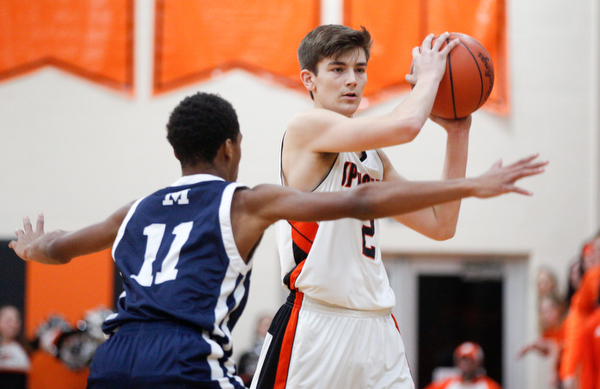 Springfield's Drew Clark looks to pass the ball while McDonald's Cam Tucker tries to block him during their game at Springfield on Friday night. EMILY MATTHEWS | THE VINDICATOR