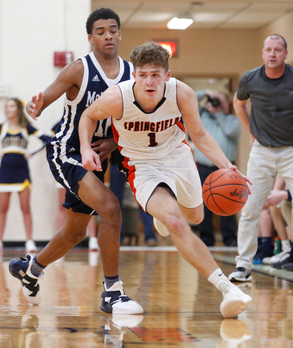 Springfield's Evan Ohlin dribbles the ball with McDonald's Cam Tucker close behind him during their game at Springfield on Friday night. EMILY MATTHEWS | THE VINDICATOR