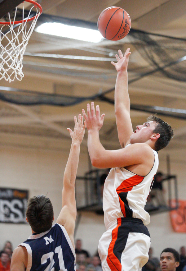 Springfield's Shane Eynon shoots the ball while McDonald's Dominic Carkido tries to block him during their game at Springfield on Friday night. EMILY MATTHEWS | THE VINDICATOR