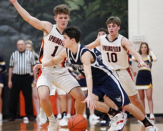 McDonald's Zach Rasile dribbles the ball while Springfield's Evan Ohlin, left, and Clay Medvec try to block him during their game at Springfield on Friday night. EMILY MATTHEWS | THE VINDICATOR