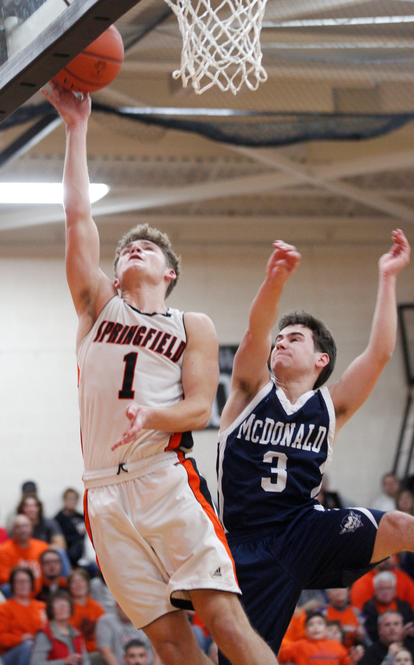 Springfield's Evan Ohlin tries to get a basket while McDonald's Parker Higgins tries to block him during their game at Springfield on Friday night. EMILY MATTHEWS | THE VINDICATOR